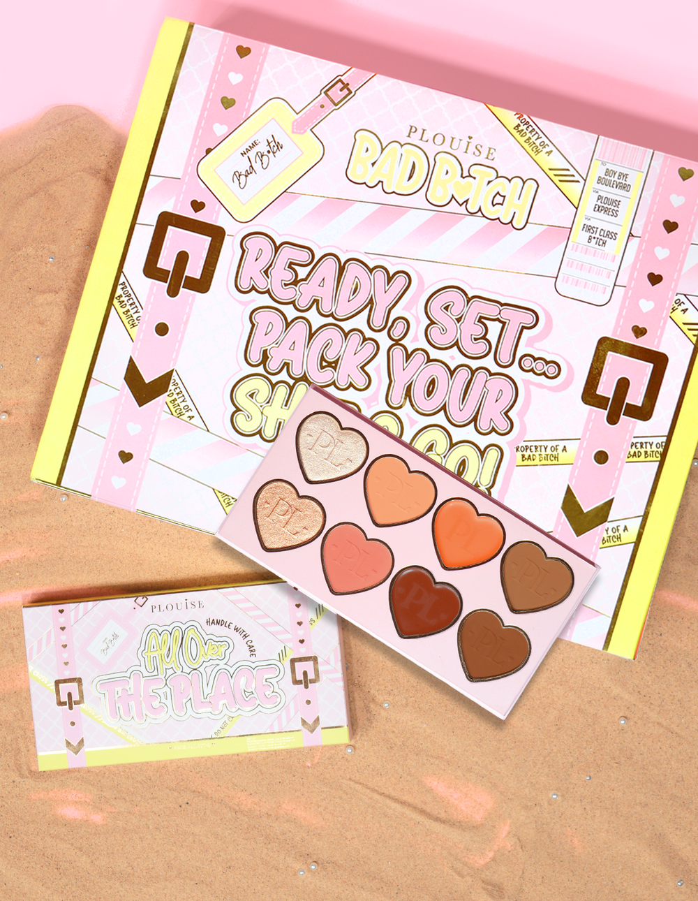 P.Louise All Over The Place Face Palette packaging and product displayed with heart-shaped pan shades in various colours on a bed of sand.