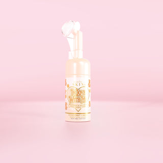Bottle of P.Louise In Love With Me foaming face wash in coconut cake on a pink background