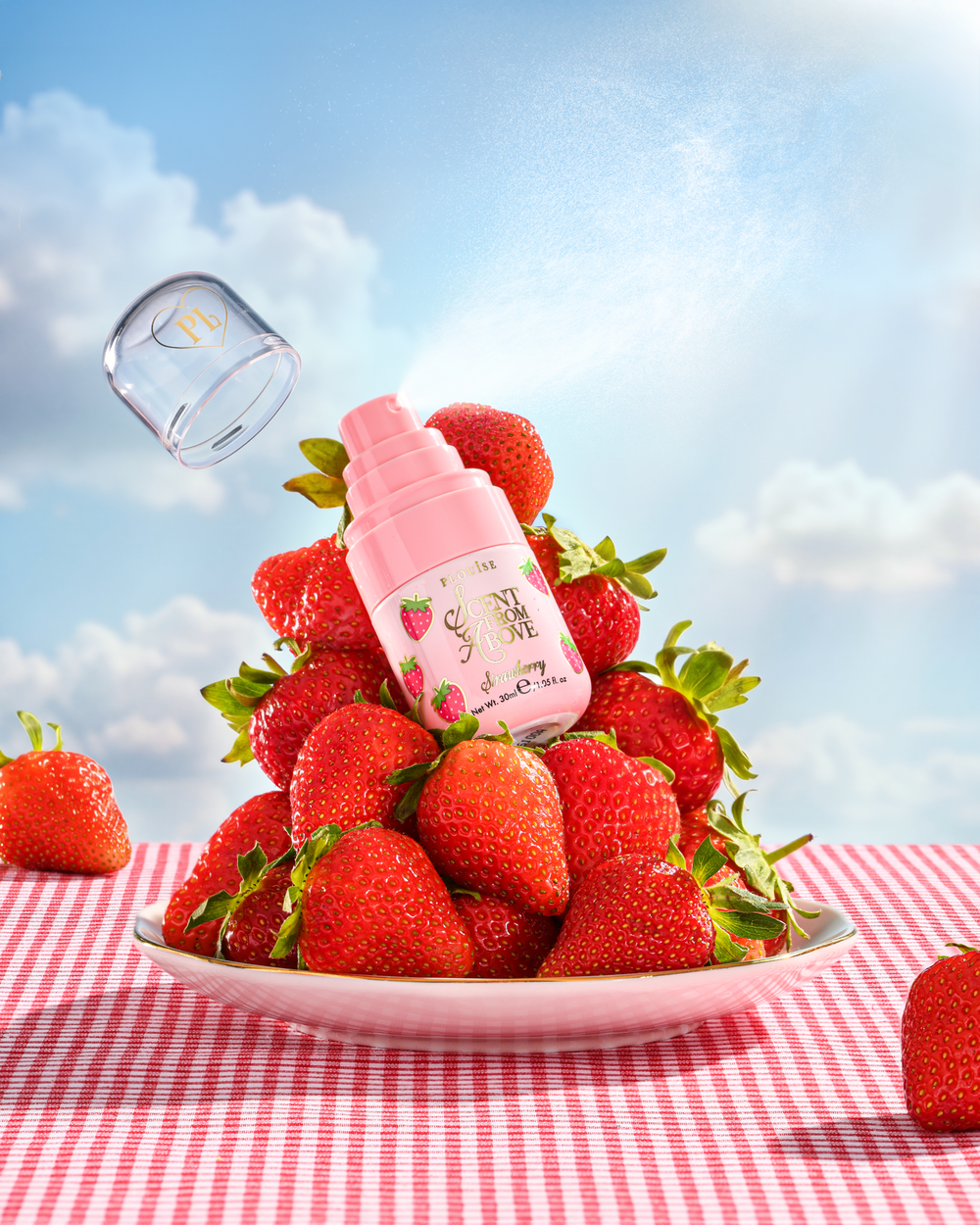 P.Louise Scent From Above Strawberry Hair & Body Mist auf einem Teller mit Erdbeeren
